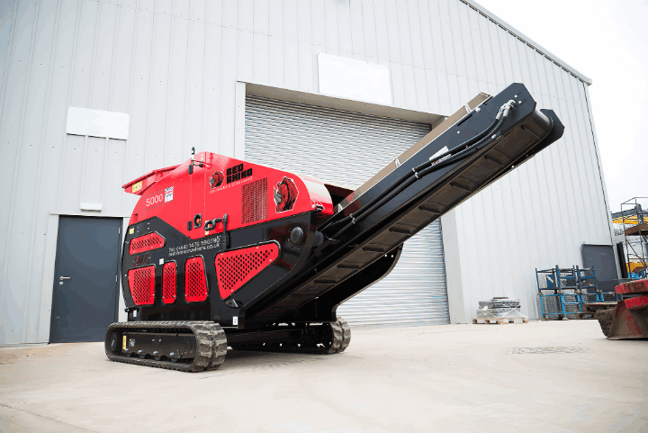 Powerful Red Rhino 5000 jaw crusher, an essential tool for material processing and recycling, showcasing its robust design in an industrial setting. Ideal for construction and demolition.